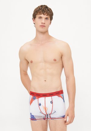 White cotton boxer shorts with a colorful fish pattern, red accents, and branded elastic waistband. Fitted design, mid-thigh length.