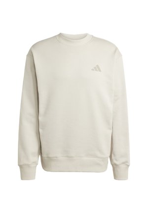 Light beige sweatshirt made of soft cotton blend, featuring a ribbed crew neck, long sleeves, and a small logo on the chest.