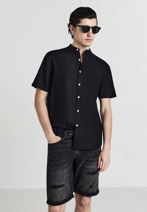 ROTTURE TOPPA - Shorts di jeans - nero denim