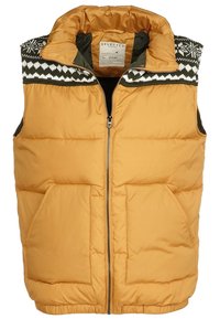 Gul pufferväst med hög krage, dragkedja framtill, två framfickor och ett mönstrat svart och vitt stickat design vid axlarna.