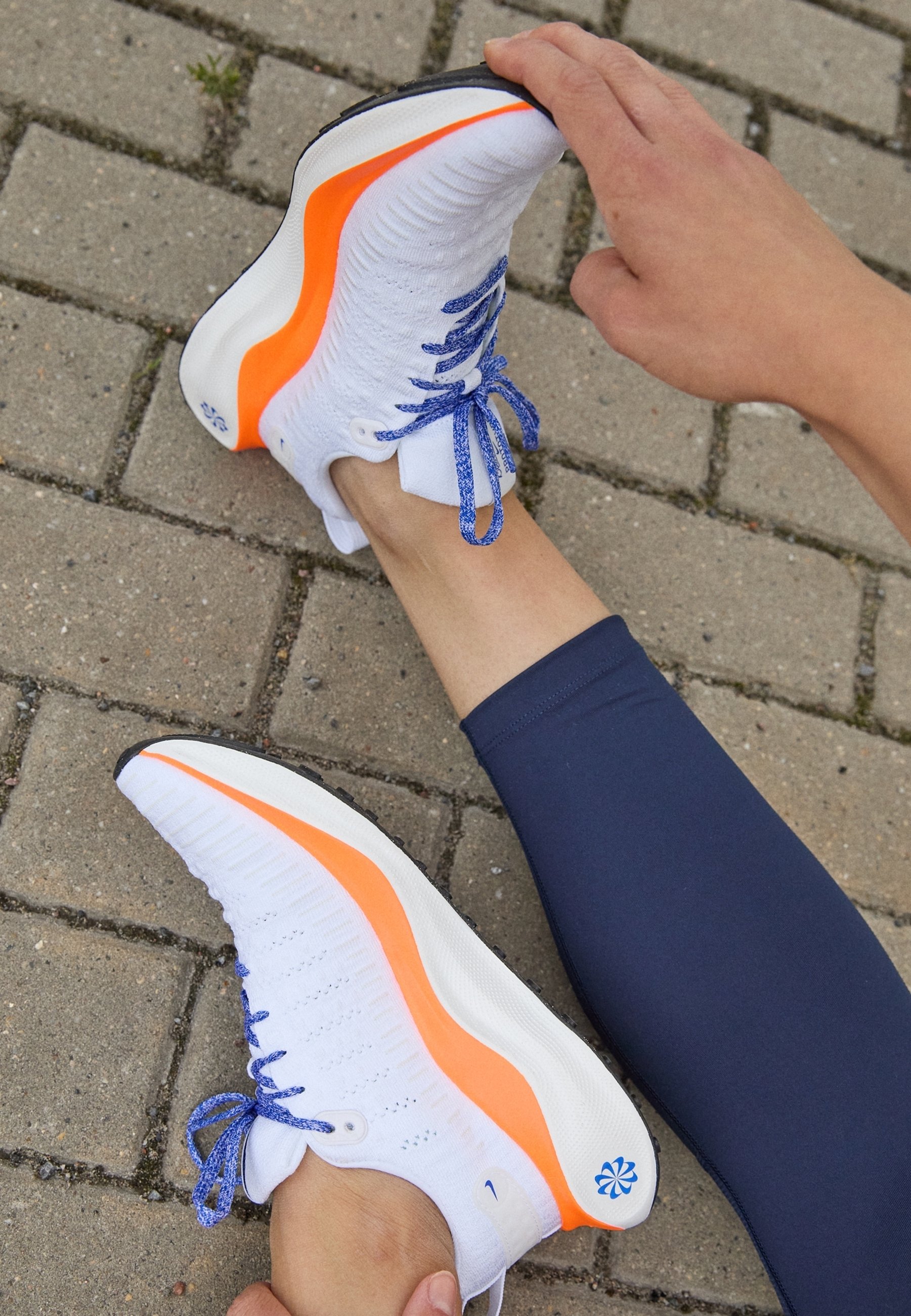 white nike shoes with orange stripe