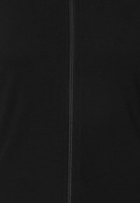 Black zip-up garment with ribbed texture, featuring a central zipper. Material appears soft and stretchy. No visible patterns or accents.