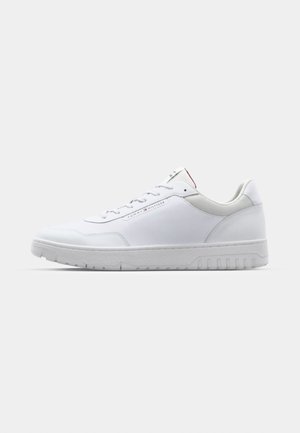 White sneaker with smooth synthetic upper, featuring lace-up front, padded collar, and textured rubber sole with slight grip patterns.
