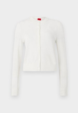 White cardigan with long sleeves, round neck, front buttons, and subtle logo detail. Soft texture and cropped design.