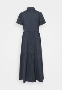 Robe en coton bleu marine à manches courtes, avec un col et une jupe en volants. Texture lisse, longueur au genou, design minimaliste.