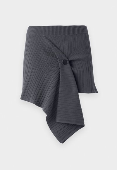 Dark gray ribbed wrap skirt with a twisted design and a round black button accent. Made from a textured, stretchy material.