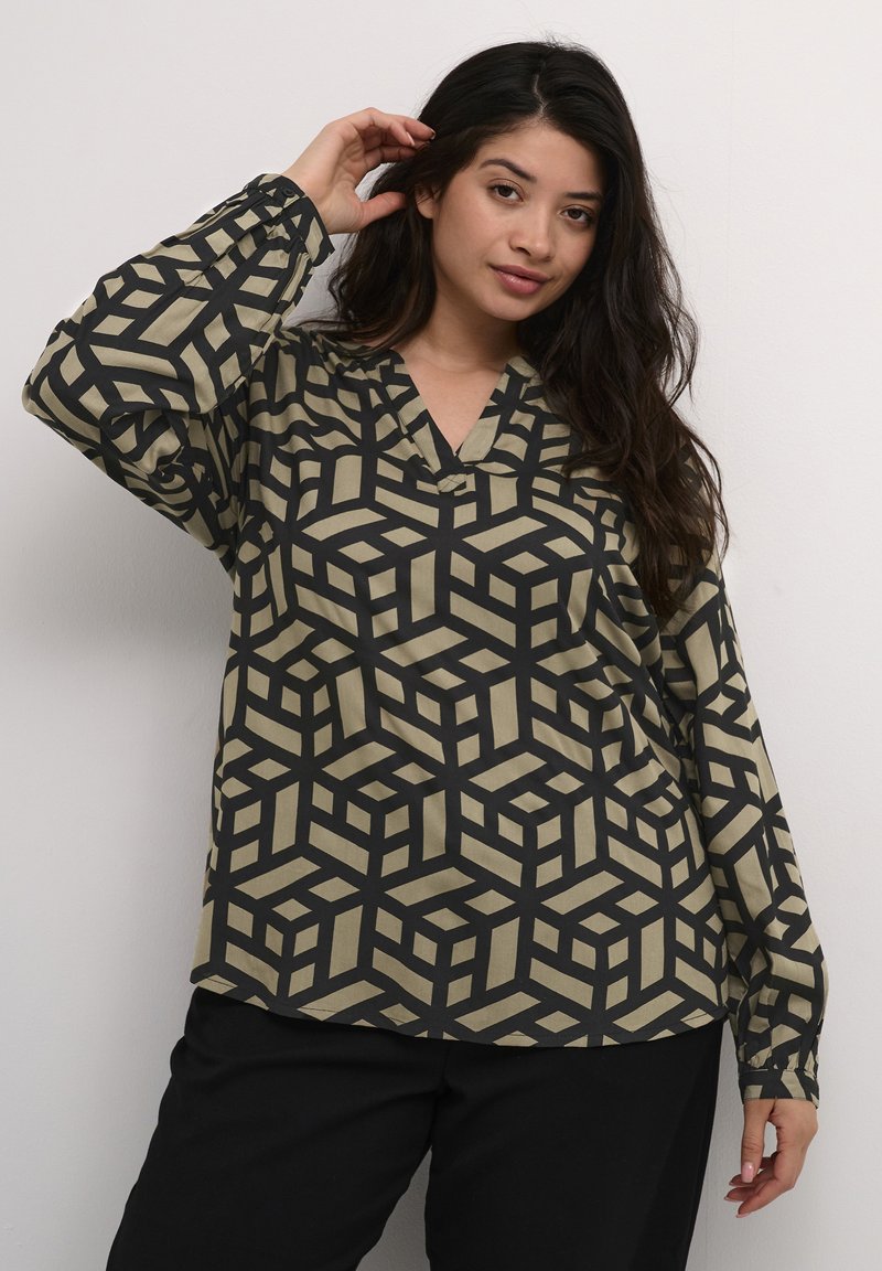 Langärmlige Bluse mit einem geometrischen Muster aus schwarzen und beigen Würfeln, V-Ausschnitt und Knopfdetails an den Manschetten.