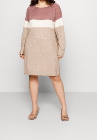 Knit dress in three colors: maroon, cream, and beige. Long sleeves, round neck, and knee-length. Smooth texture with a relaxed fit.