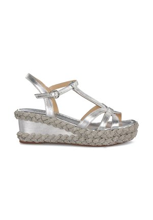 Sandalias de cuña plateadas con correas entrecruzadas, acabado metálico y base de textura tejida. Hebilla ajustable para un ajuste seguro y comodidad.