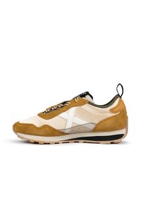 Sneaker featuring a combination of tan suede and beige fabric, white logo detail, black and beige sole, and lace-up design.