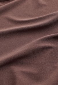 Brown fabric with a smooth texture, featuring a subtle sheen and soft draping, showing creases and folds throughout.