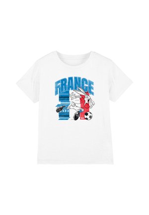 White t-shirt with blue "FRANCE" text and cartoon rabbit in red jersey kicking a soccer ball, background includes blue and red graphic elements.