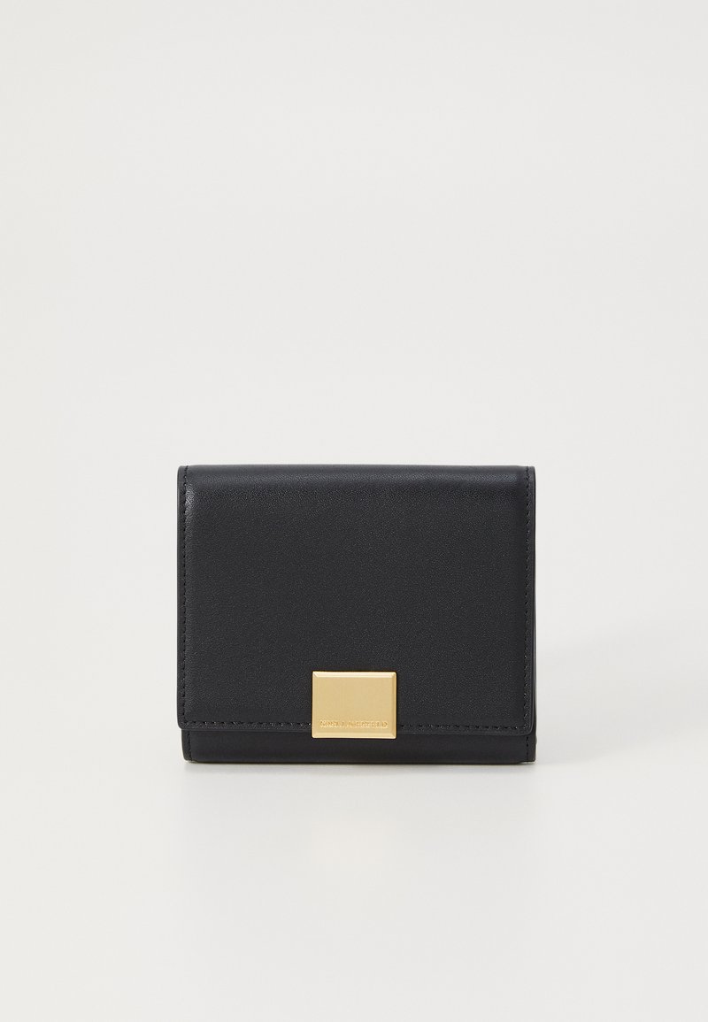 Black faux leather wallet with a rectangular shape, featuring a gold-tone hardware accent and a smooth texture. Closure flap at the front.