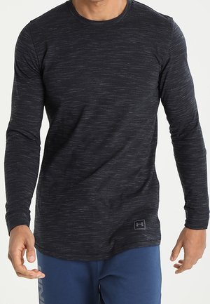 Czarna koszula z długim rękawem z teksturowanym, melanżowym wzorem. Posiada okrągły dekolt oraz logo Under Armour na lewej dolnej stronie.