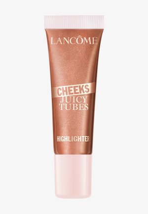 Illuminateur Lancome Cheeks Juicy Tubes dans un tube bronze brillant avec un capuchon rose pâle.