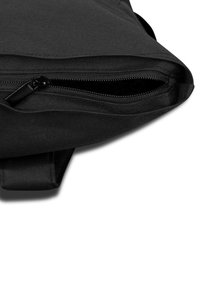 Black fabric pouch with partially open zipper on a white background, showing textured material and stitching details.