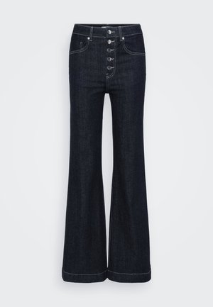 Mörk denimflared jeans med hög midja, fem framknappar och kontrasterande vit sömnad längs sömmarna och fållen. Klassisk design.