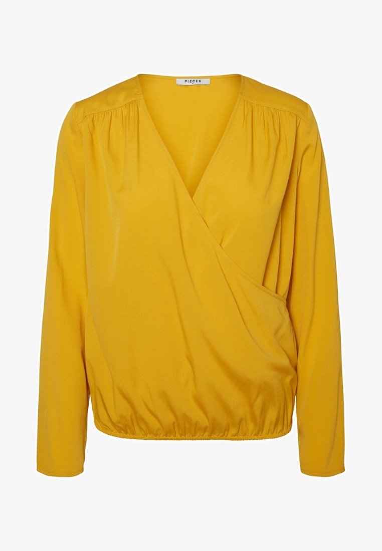 Žlutá zavazovací blůza s dlouhými rukávy, vyrobená z hladkého materiálu. Má nařasený pas a hluboký výstřih do V.
