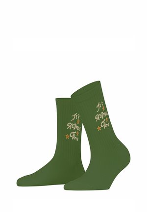 Paire de chaussettes côtelées vertes avec un texte beige disant "It's Xmas Time" et de petites étoiles beiges sur les côtés extérieurs.