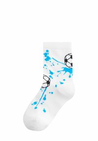 Calza di cotone bianca con design di un pallone da calcio in bianco e nero, arricchita da spruzzi di vernice blu. Lunghezza a metà polpaccio con bordo rigato.