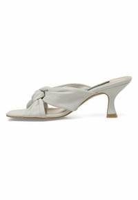 Light gray leather open-toe heeled sandals with a knotted front design, featuring a tapered heel and smooth texture.