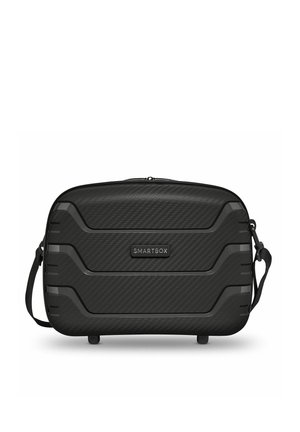 Zwart harde SMARTBOX-tas met een gestructureerd oppervlak, horizontale ribbels, ritssluiting bovenaan en verstelbare schouderriem.
