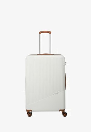 White hard-shell suitcase with vertical ribbed texture, brown accents, extendable handle, and four wheels for mobility.