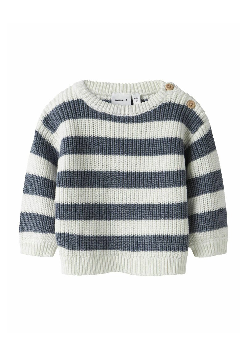 Maglione a righe in crema e blu navy, texture lavorata a maglia, colletto rotondo, maniche corte, con due bottoni in legno sulla spalla.