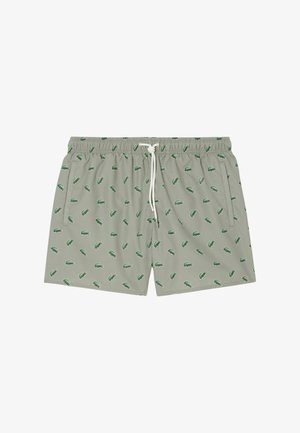 Badeshorts, hellgrau mit grünem Krokodil-Muster, elastischer Bund mit Kordelzug, Seitentaschen und glatter Stofftextur.