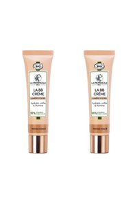 Deux tubes beige de "La BB Crème," chacun avec des accents dorés, portant des étiquettes en vert et noir, indiquant une composition naturelle.