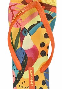 Chanclas coloridas con una plantilla texturizada y estampada con diseños tropicales y una tira de goma en forma de Y de color naranja. El nombre de la marca "Hotmarz" es visible.