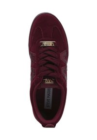 Burgundy sneaker with suede upper, speckled fabric accents, gold hardware on tongue, and textured detail on the sides.