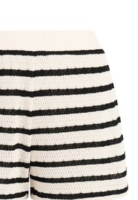 Gebreide korte broek met horizontale zwarte en witte strepen en een brede geribbelde witte tailleband.