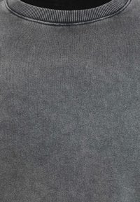 Grijze sweatshirt met een geribbelde ronde hals, gemaakt van zachte, gestructureerde stof, met een uniforme kleur en subtiele variaties in toon.
