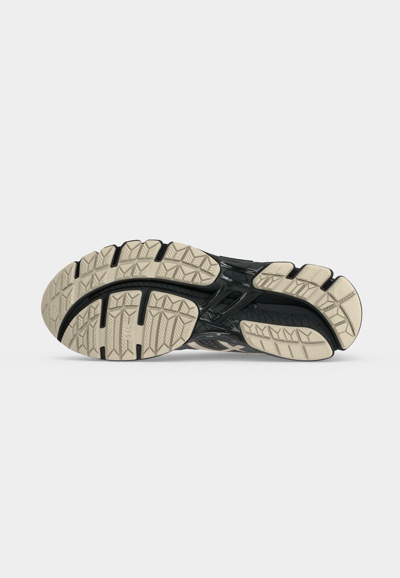 Suela de zapato con banda de rodadura texturizada beige y soporte intermedio negro, diseñada para agarre y durabilidad en superficie plana.