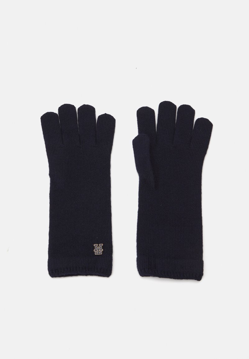 Navy blue fingerless gloves made of knit fabric, featuring a ribbed texture and a small gold logo accent at the wrist.