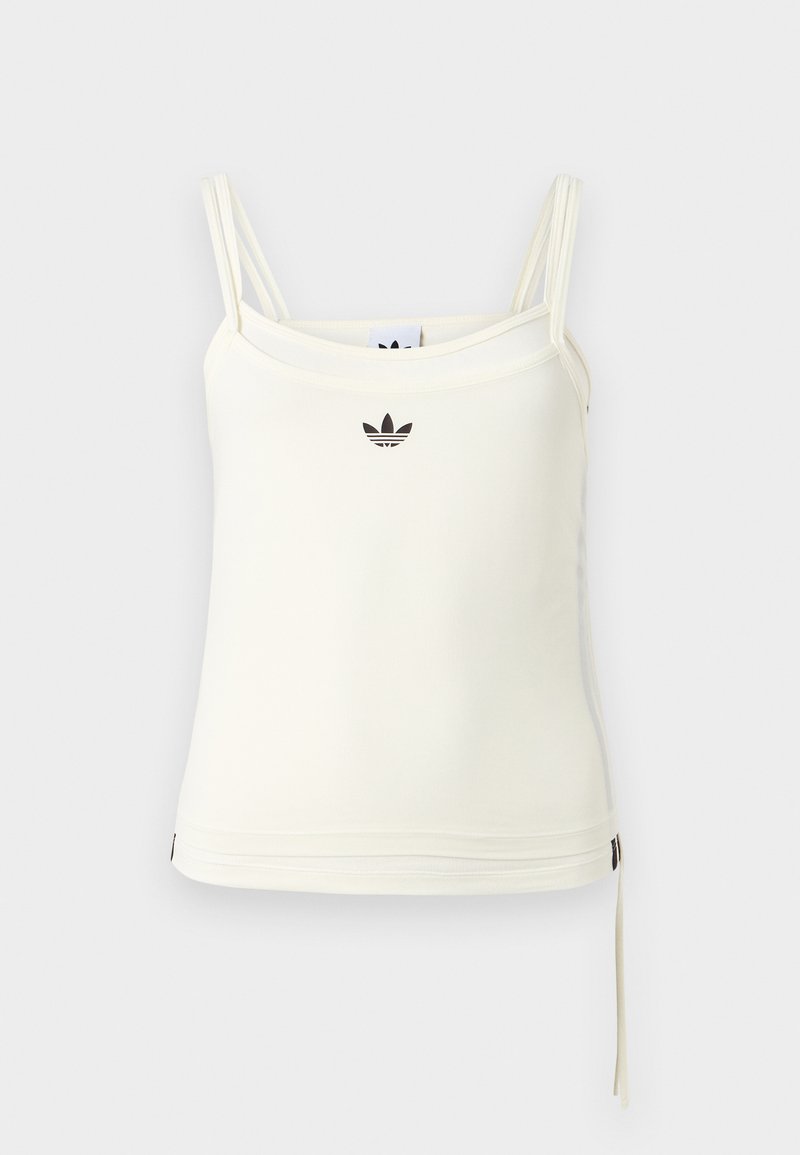 Débardeur crème à fines bretelles ; logo Adidas noir sur la poitrine. Tissu lisse avec un cordon de serrage au bas. Design simple.