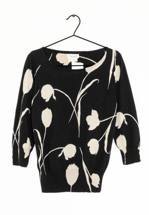 Black long-sleeve sweater with white abstract floral pattern, round neckline, and three small buttons on each cuff, hanging on a black hanger.