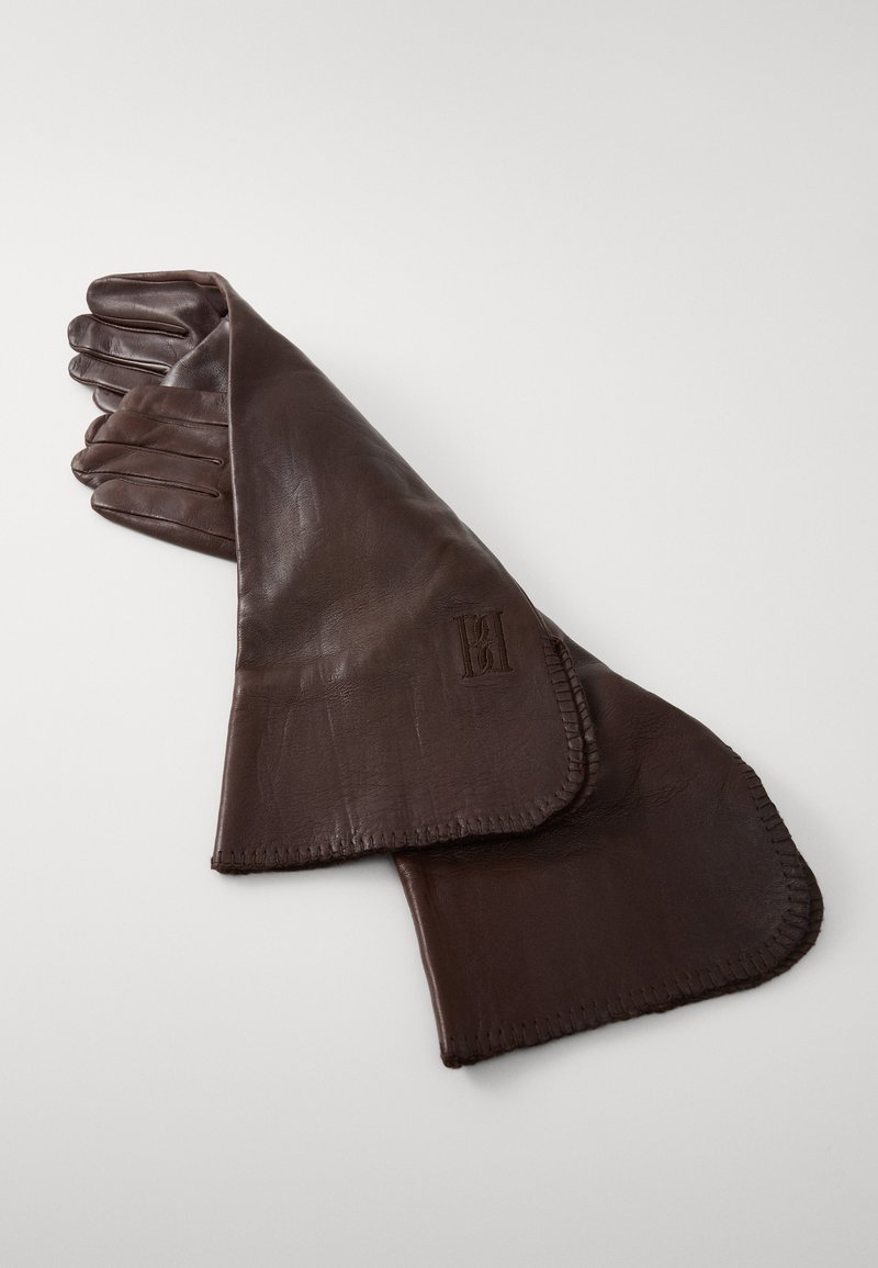 Brown leather gloves with a smooth texture, featuring stitched edges and an embossed logo on the cuff. Five-finger design, mid-length style.