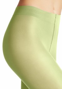 Lichtgroene leggings met een gladde, strakke textuur, voorzien van een hoge tailleband en naadloze stiksel langs de zijkanten.