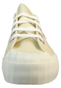 Sneakers sznurowane z teksturowaną, jas yellow kanwą, białymi sznurówkami i grubą, żebrowaną, białą gumową podeszwą.