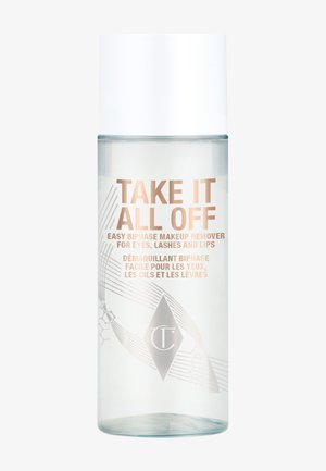Bouteille en plastique transparent avec un capuchon blanc, contenant un démaquillant biphasé. Présente un motif en relief et un texte imprimé en or et en argent.