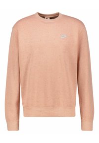 Růžová mikina vyrobená z texturované tkaniny, s kulatým výstřihem, dlouhými rukávy a malým logem Nike na hrudi.