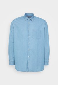 Jasnoniebieska koszula na guziki z bawełny, z kieszenią, kołnierzykiem i długimi rękawami zakończonymi mankietami na guziki. Czysty, klasyczny design.