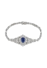 White gold bracelet featuring an oval blue sapphire surrounded by round and marquise-cut diamonds in a floral design.
