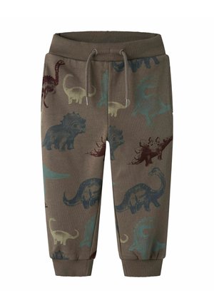 Pantaloni della tuta marroni con una combinazione di stampe di dinosauri in blu, verde e bordeaux. Vita e polsini elastici, materiale in cotone morbido.