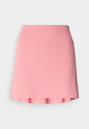 Różowa sportowa spódnica wykonana z elastycznego materiału, z gładkim paskiem w talii i rozkloszowanym dołem z plisowanymi akcentami. Brak widocznych logo.