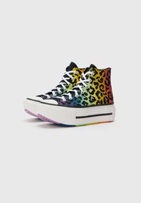 High-top sneakers with a multicolored leopard print. Canvas material, white laces, platform sole with a colorful gradient on the bottom.