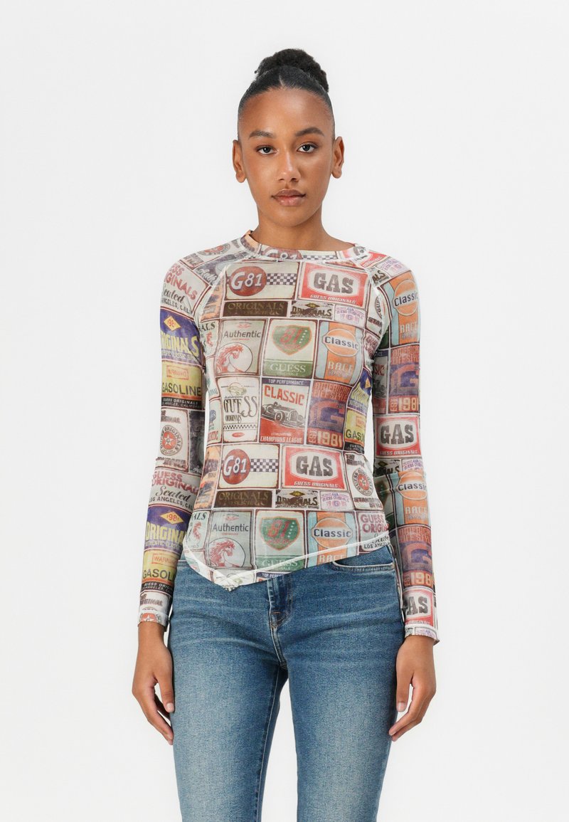 Long-sleeve, fitted top made of sheer fabric, featuring a colorful collage of vintage gas station graphics and logos.