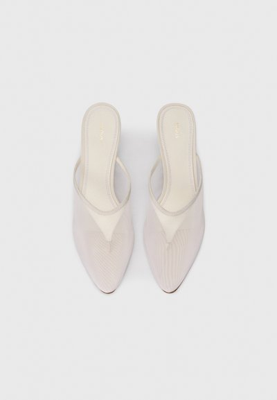 Pair of beige pointed-toe mesh slingback sandals with low heels and branded insoles on a plain light gray background.